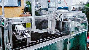 Automatic cartoning machine for packing blisters and plastic tubes into boxes