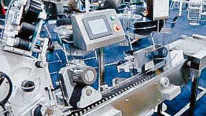 Automatic labeling machine for sticking labels on glass ampoules and vials