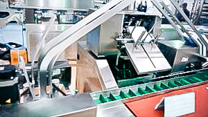 Automatic equipment for filling blisters in cardboard boxes