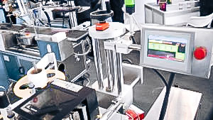 Automatic equipment for sticking self-adhesive labels on bottles of pharmaceutical production