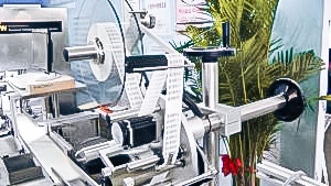 Automatic equipment packaging of cardboard boxes in cellophane in pharmaceutical production USA